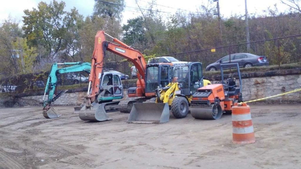 A1 excavators and loaders lined up at the equipment yard