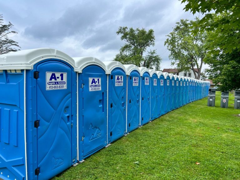Row of A1 portable toilets set up on a lawn